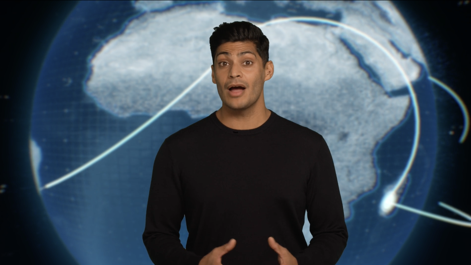 Image of presenter in front of a screen displaying a large blue globe